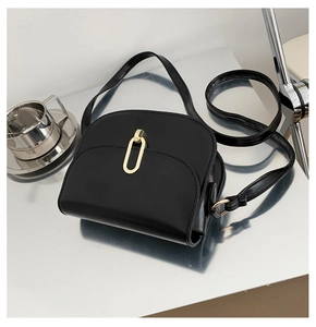 Detailansicht der schwarzen Satteltasche mit goldener Ring-Schnalle und Leder-Schultergurt