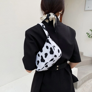 French style cow print shoulder bag in black and white canvas with minimalist half-moon shape