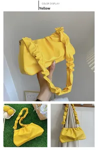 Detailed views of yellow ruched cloud bag showing pleated texture and chain strap