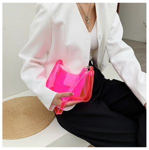 Detail of neon pink and orange gradient transparent PVC shoulder bag with zipper closure