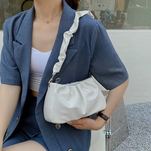 White minimalist pleated cloud bag for women shown as an underarm shoulder bag