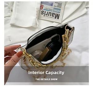 Internal capacity of white crocodile pattern crescent bag with dual gold chain straps