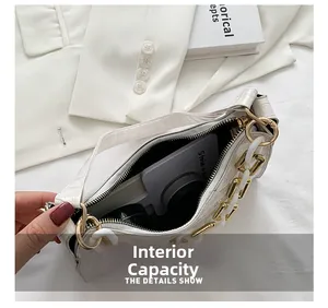 Interior view of white crocodile pattern baguette bag showing capacity for daily essentials