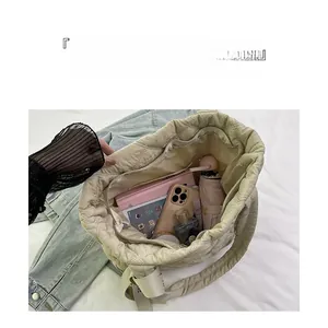 Detailed interior view of a beige quilted tote bag showing large storage capacity and compartments