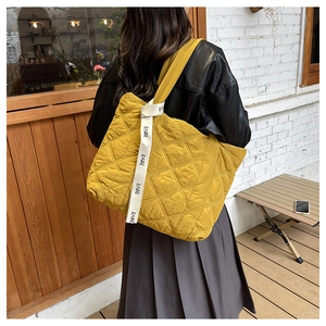 Ginger yellow quilted oversized tote bag with diamond stitching and lettered shoulder strap