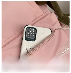 Detailed macro view of the pink backpack front zipper pocket and translucent logo