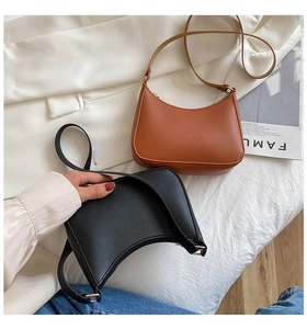 Detail view of stylish hobo shoulder bags in black and caramel brown leather textures