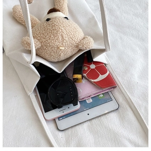 Interior view of white canvas bear tote bag showing spacious capacity for daily essentials