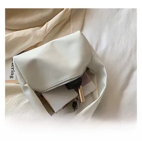 Interior view of soft cream leather handbag showing capacity for phone and cosmetics