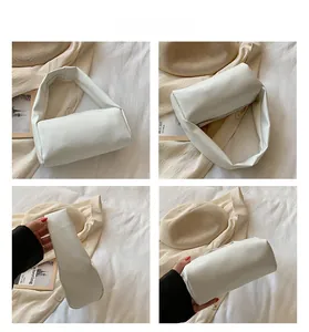 Detail view of a white minimalist rectangle handbag with wide straps in soft leather style