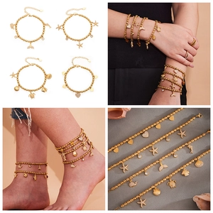 Detail of gold beaded bracelet set with ocean pendants like turtle and starfish charms