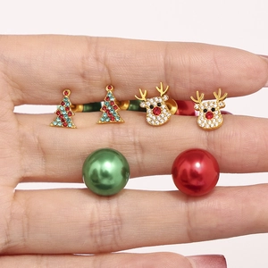 Detail of Christmas earring set with reindeer, tree studs and red green pearl backing