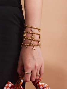 Close-up of a 7-piece jewelry set featuring starfish and heart charms on a wrist