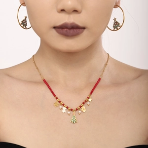 Detailed view of Christmas earrings with shiny zircons and festive enamel charms