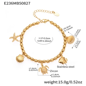 Detail of gold stainless steel ocean charm bracelet with starfish, shell, and turtle