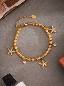 Detailed shot of stainless steel starfish bracelet with sparkling zircon charms