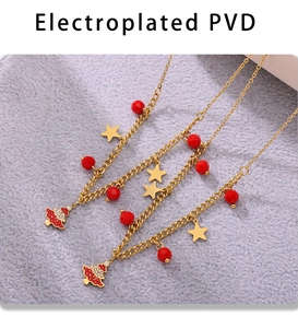 Detailed view of PVD plated Christmas tree pendant necklaces with red enamel and zircon