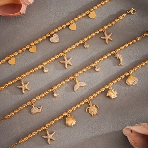 Golden beaded bracelets with marine charms like ocean starfish and sparkling hearts