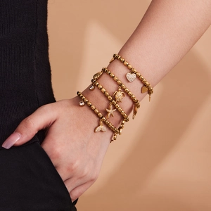 Gold beaded bracelet set with sparkling ocean charms including starfish and turtles