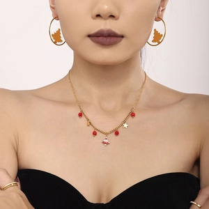 Golden Christmas tree necklace and hoop earring set with red beads and enamel detail
