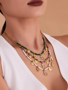 Detailed close-up of three-layer beaded necklace with octopus and shell charms