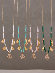 Detailed view of ocean style beaded necklaces with diamond-set octopus and shell pendants