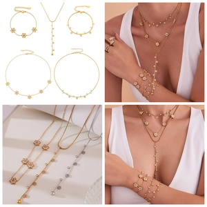 Detailed set of floral jewelry with necklaces, bracelet, and ring featuring white zircons