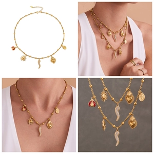 Detailed view of gold beaded necklace featuring lucky charms like ladybug and heart pendants