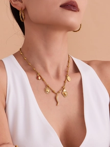 Detailed view of gold multi-charm necklace and twisted earrings worn by model