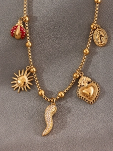 Detailed close-up of golden link chain necklace featuring enamel and zircon charms