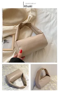 Close-up of khaki minimalist cylindrical handbag with matte PU leather texture