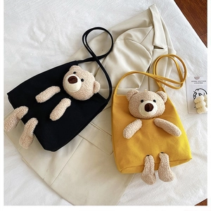 Detail of canvas tote bag with 3D teddy bear plush decoration in black and yellow