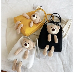 Detailed view of three canvas bags featuring cute 3D plush teddy bear decorations
