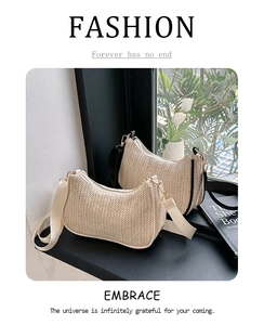 Detail of hand-woven straw tote bags with contrasting leather straps and gold metal hardware