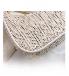 Close-up of beige woven straw tote bag with V-shaped texture and faux leather piping details