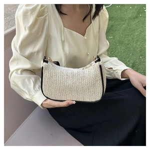 Chic woven straw tote bag for women with black leather trim and gold hardware details