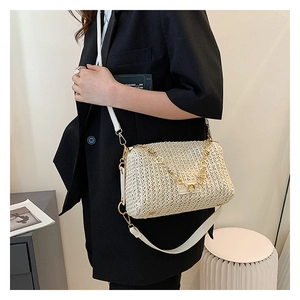Detailed close-up of beige woven texture crossbody bag with gold chain and leather strap