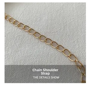Macro detail of high-shine gold metal chain shoulder strap for stylish shell bags