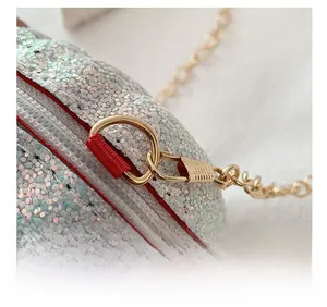 Detailed macro view of the silver sequin bag featuring a smooth contrast zipper and gold chain