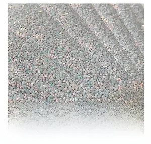 Macro shot of high-density iridescent hexagonal sequins on a shell-shaped chain bag