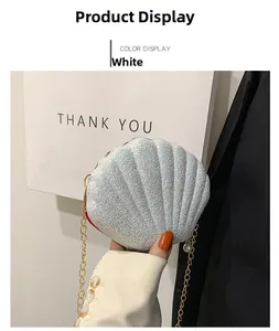 Close-up of white sequin shell bag with golden chain and a decorative pearl pendant