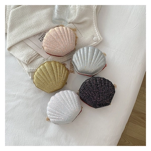 Detailed close-up of shell-shaped chain bags with glitter texture and golden metal chains