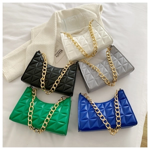 Flat lay of five quilted shoulder bags in neutral and pastel colors with gold chains