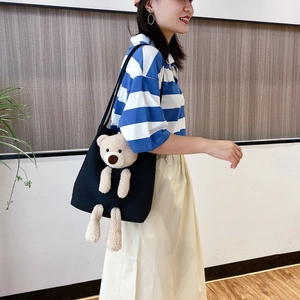 Large black canvas tote bag for women featuring a 3D plush teddy bear on front