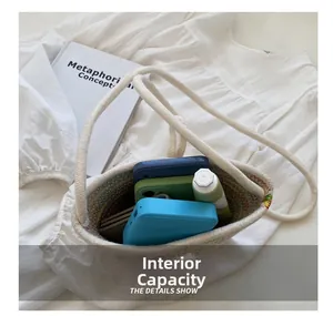 Internal capacity of the white woven bucket bag showing mobile power and phone cases