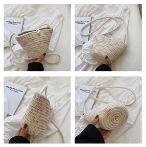 Detail view of woven bucket bag with colorful wavy patterns and a pearl button closure