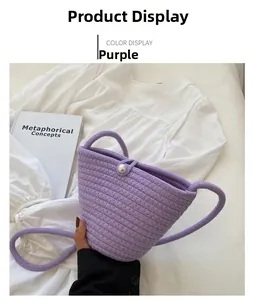 Close-up of purple woven bucket bag featuring pearl clasp and fine braided strap