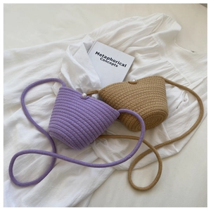 Close-up of woven bucket bags with pearl closures and soft cotton rope shoulder straps