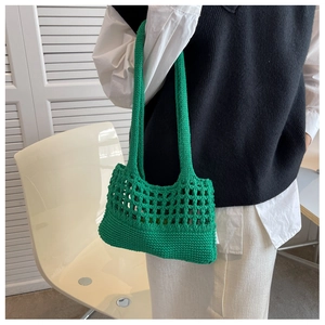 Dettaglio della borsa shopper verde intrecciata con design a rete e manici resistenti