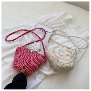 Detail of colorful woven bucket bags with pearl closure and braided rope handles
